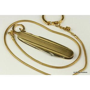 A pocket knife on chain. Gold plated elongated oval shaped…