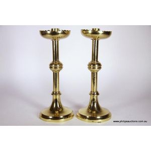 A pair of ecclesiastical style brass candlesticks, with maker's…