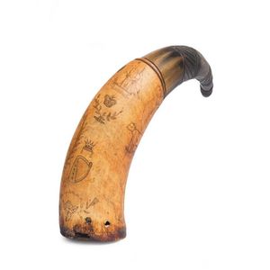 A powder horn with scrimshaw decoration of tall ship, harp,…