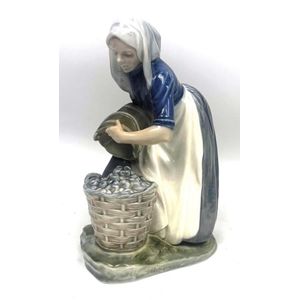 A Royal Copenhagen porcelain figure of a women collecting&hellip;