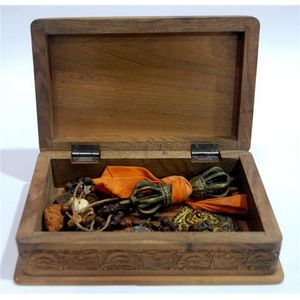 A sandalwood box with a Tibetan Dorji, votive beads and…