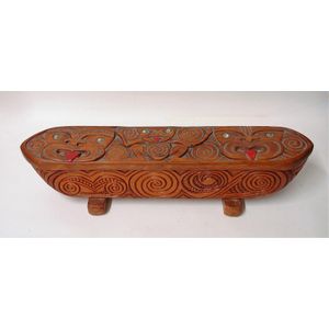 A 1947 Jane Brenkley carved and decorated waka huia, the hinged…