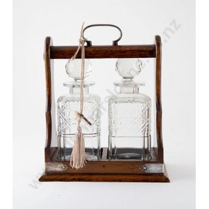 Edwardian oak 2 division tantalus, with 2 square cut glass…