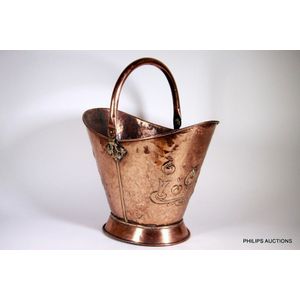 An Arts & Crafts copper coal scuttle, late 19th century, the…