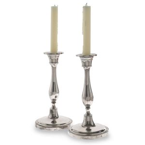 A pair of antique Sheffield plate candlesticks, the rounded…