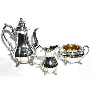 A silver plate tea service, including a teapot, creamer & sugar…