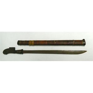 A Toraja sword, plain blade with some pitting, handle carved…