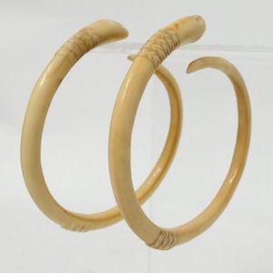 A pair of old highly curved boars tusk earrings, each with…