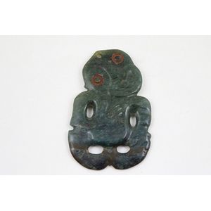 19th century pounamu hei tiki head inclined to left, left arm…