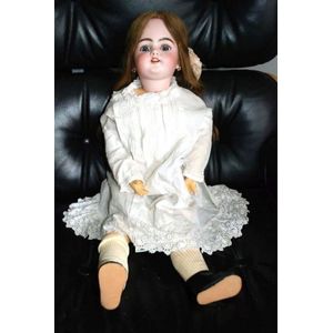 A Simon & Halbig porcelain headed doll, glass eyes, four teeth…