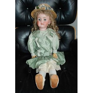 A Simon & Halbig porcelain headed doll, glass eyes, four teeth…