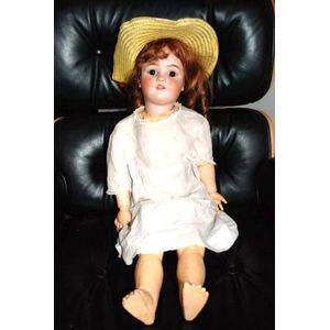 A Simon & Halbig porcelain headed doll, glass eyes, four teeth…