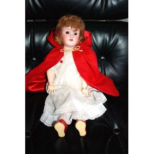 A Simon & Halbig porcelain headed doll, glass eyes, four teeth…