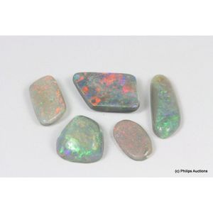 A collection of five semi black solid opals, comprising five…