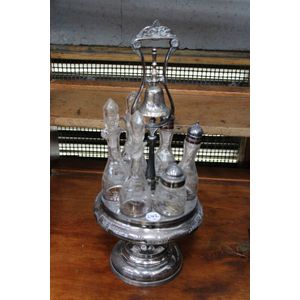 Revolving cruet set with 6 bottles on plated base