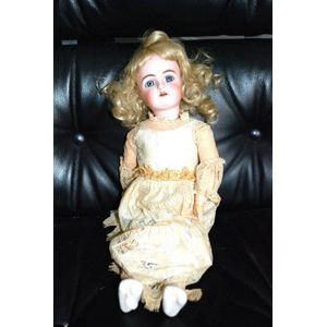 A porcelain headed doll, glass eyes, four teeth upper, with…