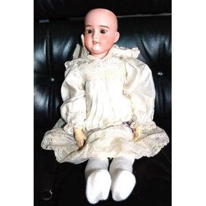 A porcelain headed sleeping eye doll, four teeth upper, with…