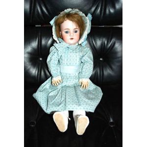 A DEP porcelain headed doll, glass eyes, five teeth upper, with…