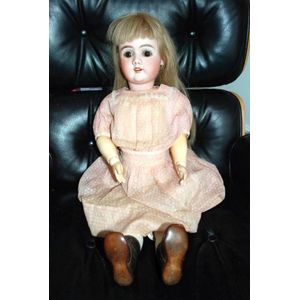 A porcelain headed sleeping eye doll, painted four tooth bar…