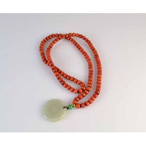 A Chinese strand of carved coral beads with hard stone pendant.&hellip;