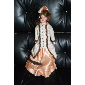 A porcelain headed doll, glass eyes, four teeth upper, with kid…