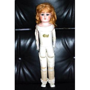 A German porcelain headed doll, glass eyes, three teeth upper,…
