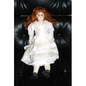 A porcelain headed doll, glass eyes, kid leather body,…