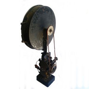 An early 20th century movie projector, hand operated, black and…