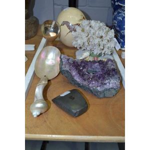 Crystal ball on stand, axe head, shell spoon, coral display…