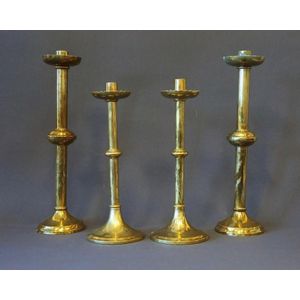 Two graduated pairs brass church candlesticks. Height 33 cm.…