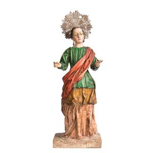 A carved and gessoed polychrome figure of a female saint,…