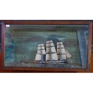 Antique sailing ship & steam boat diorama, both flying red…