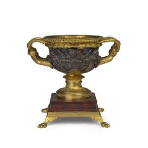 An ormolu and bronze urn mounted on a rouge marble base,…