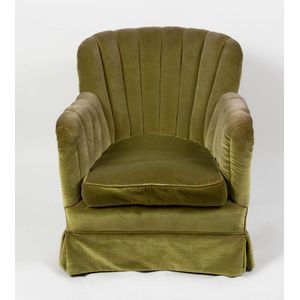 A chartreuse velvet upholstered bedroom chair in the Art Deco…