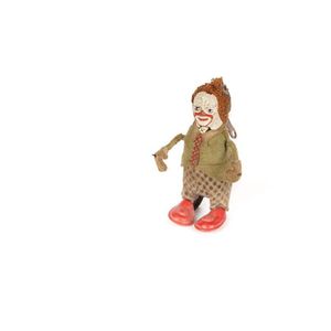 A small Schuco tinplate clockwork clown toy, working, with…
