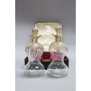 Antique boxed pair of decanters, hour glass form mounted with…