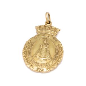 A gold religious medal, featuring Mary and Jesus to a wreath…