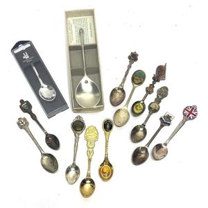 A collection of tourist spoons including England, Westminster…