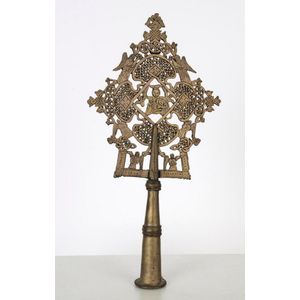 An Ethiopian Orthodox processional cross adorned with the…