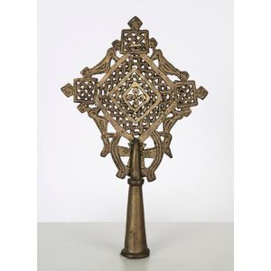 An Ethiopian Orthodox processional cross adorned with bird…