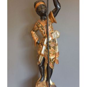 Blackamoor figurine a figure holding a stave, clothed in rich…