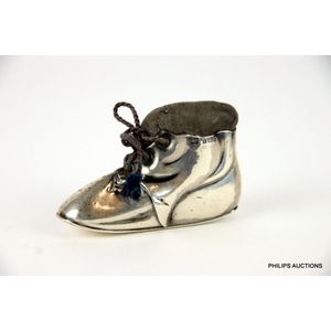 A novelty sterling silver pin cushion in the form of a boot,…