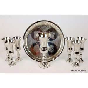 A George V sterling silver set of seven kiddush cups & tray,…