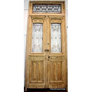 A pair of large French wrought iron and pine doors, second half…