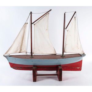 A vintage pond yacht with sails, circa 1930, 90 cm long