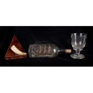 A model ship in a bottle, whales tooth plaque and antique ale…