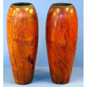 Two vintage Australian pokerwork vases, one decorated with a…