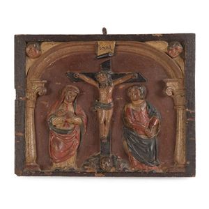 A Bohemian polychrome carved wooden panel of the crucifixion,…