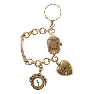 A vintage gold bracelet watch with Charms, 9ct watch retailed…