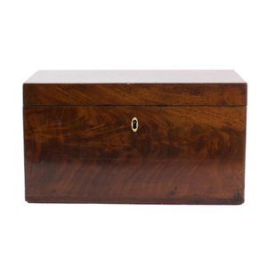 An English flame mahogany tea caddy, 19th century, the hinged…
